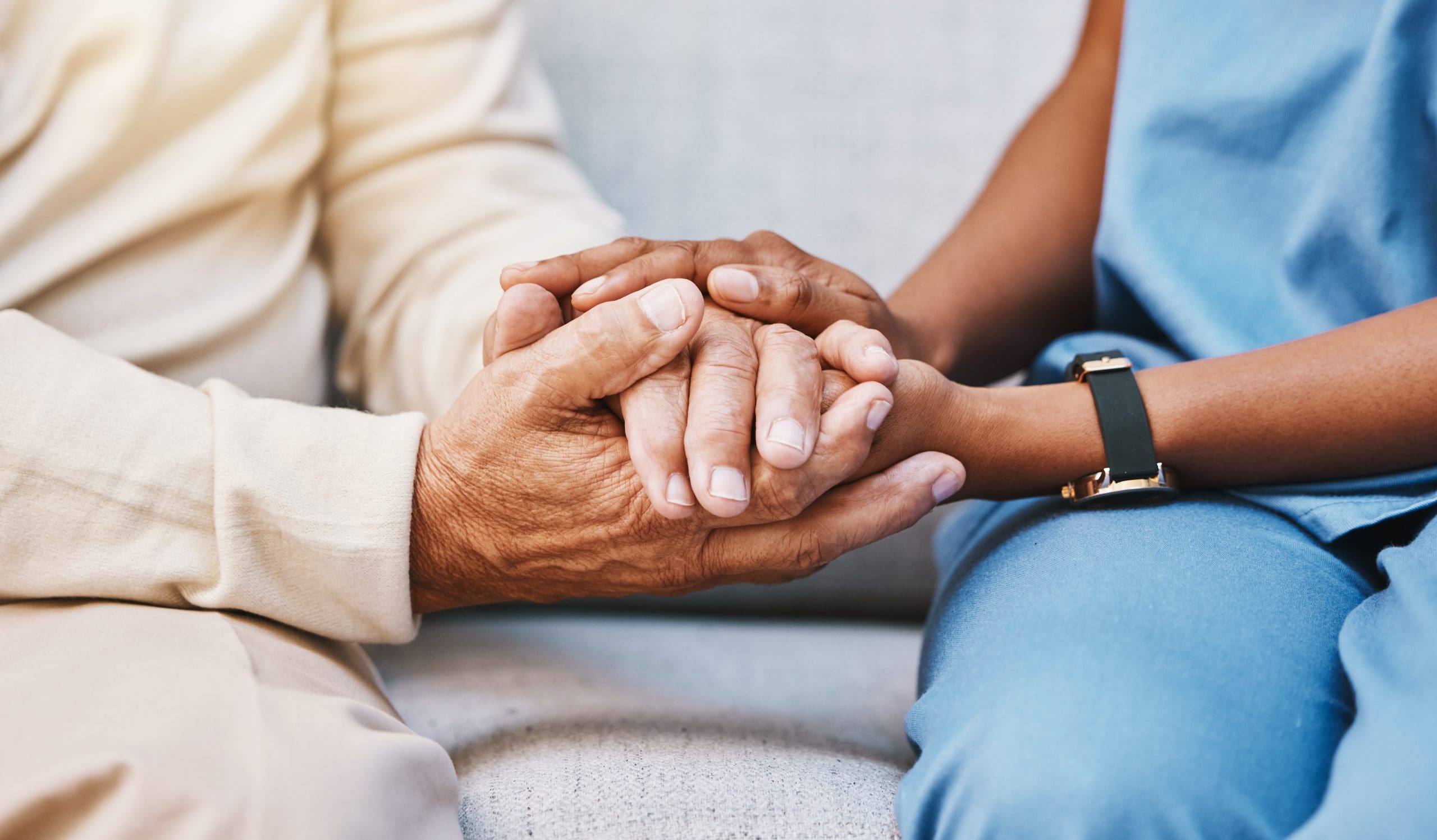 Comforting hand-in-hand moment between caregiver and senior resident at Walking Horse Meadows in Clarksville, Tennessee.