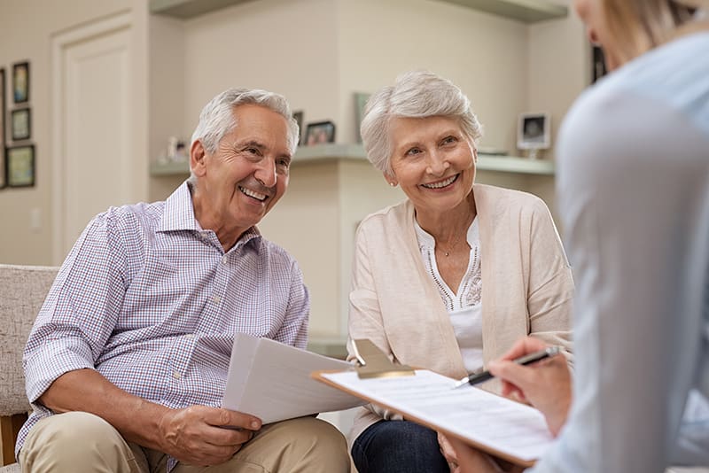 Senior residents meeting with friendly staff member for personalized care planning at Walking Horse Meadows, Clarksville, TN.