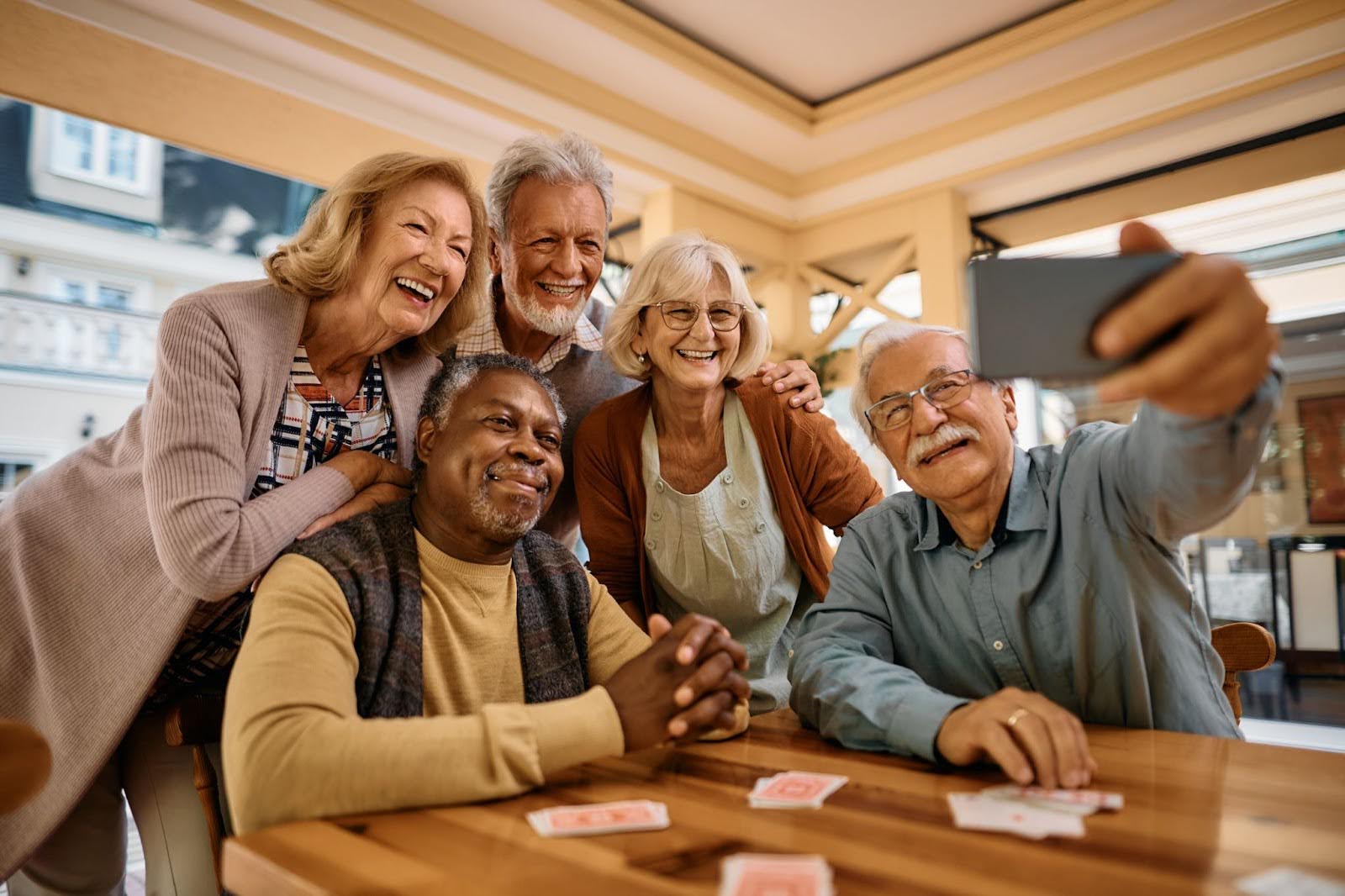 Group of senior friends happily taking a selfie during social activities at Walking Horse Meadows, Clarksville senior community.
